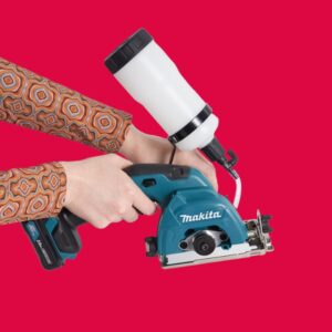 Female holding Makita Tile cutter on red background