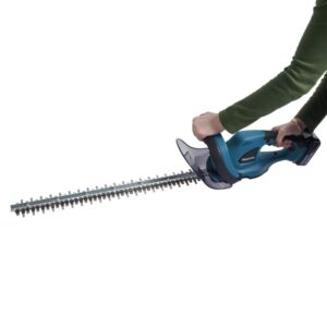 female holding hedge trimmer