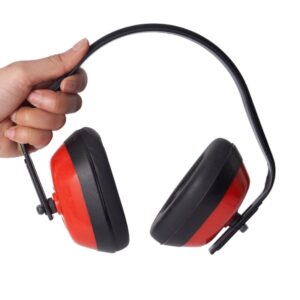 South Asian holding ear defenders