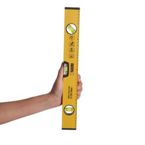 South asian female holding small yellow spirit level